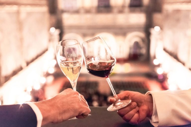 toast with a glass of wine anche champagne in salone dei 500 in Palazzo Pittti, Florence