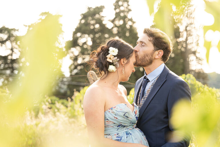 bride and groom kiss at the sunset